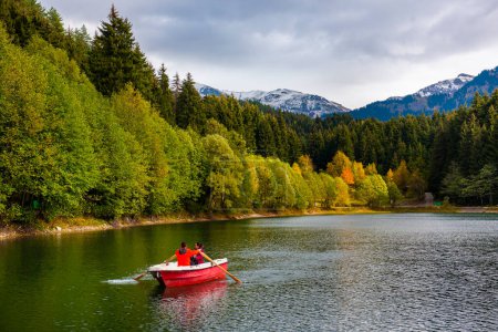 Photo for Karagol Lake in Savsat. Artvin, Turkey. Autumn view in Karagol. Beautiful colors and landscape with reflection on lake. Lake in Sahara National Park. Couple on boat. - Royalty Free Image