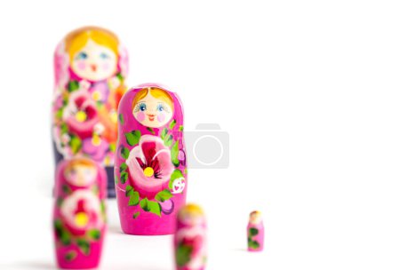 Photo for Russian Matryoshka Dolls in different sizes. Traditional Matryoshka set in a row. Set of wooden toys on white background. - Royalty Free Image
