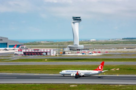 Photo for Istanbul, Turkey - June 3, 2023: Turkish Airlines airplane with Air Traffic Control Tower of Istanbul Airport. View of international Istanbul New Airport. - Royalty Free Image