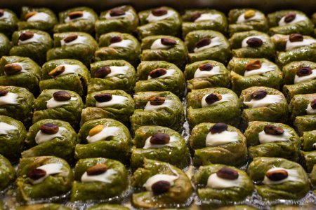 Photo for Turkish sweet baklava on tray. Traditional Baklava from Gaziantep, Turkey. Baklava with pistachio. - Royalty Free Image