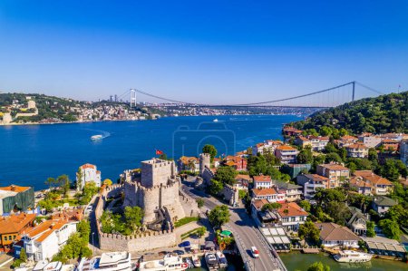 Fatih Sultan Mehmet Bridge and Anadolu Hisari (Anatolian Fortress) in Istanbul, Turkey. Beautiful Istanbul bosphorus landscape. Drone shot.