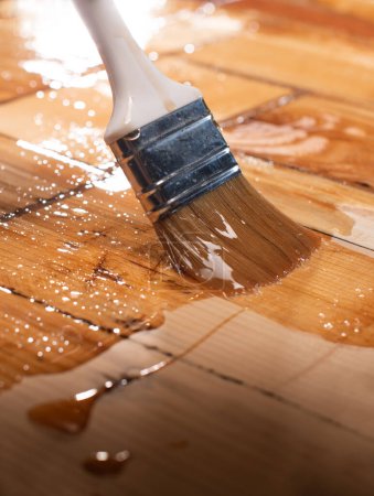 Photo for Wood Staining Closeup. Closeup of a hand applying stain on wood - Royalty Free Image