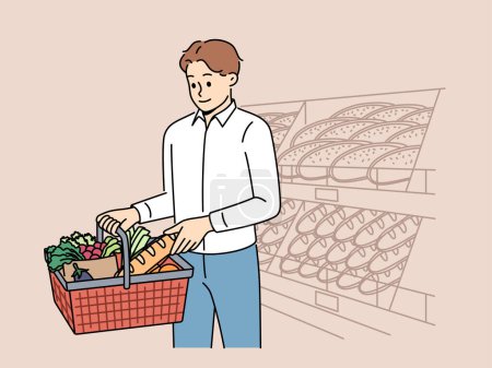 Man customer at grocery supermarket takes bread from shelf and puts it in basket of groceries. Guy visits supermarket or bakery buying fresh baguette and organic vegetables for preparing lunch.