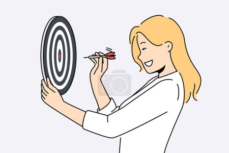 Determined woman throws darts at target for concept of business success and achieving set goals. Goal oriented businesswoman with darts board smiling setting and achieving ambitious goals