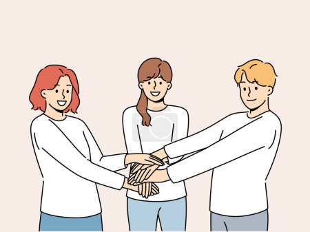 Friendly team of people holding hands demonstrate cohesion and unity, wanting to achieve goals together. Team of young guy and two girls carrying out volunteer or charitable activities