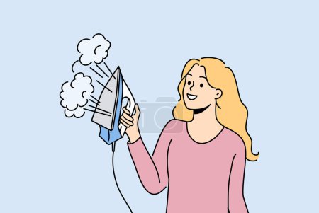 Illustration for Woman housewife holds iron with steam function and smiles enjoying doing housework. Modern iron releasing steam in beautiful hands of girl taking care of clothes after washing in laundry - Royalty Free Image
