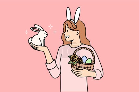 Teenage girl celebrating easter holds decorated eggs in basket and small rabbit, rejoicing at coming of spring. Schoolgirl is preparing for easter and bringing traditional gifts to friends from school