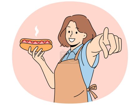 Téléchargez les photos : Femme souriante dans le tablier tenant le point de hot dog à l'écran. Serveuse heureuse avec fastfood dans les mains montrent à la caméra avec le doigt. Illustration vectorielle. - en image libre de droit