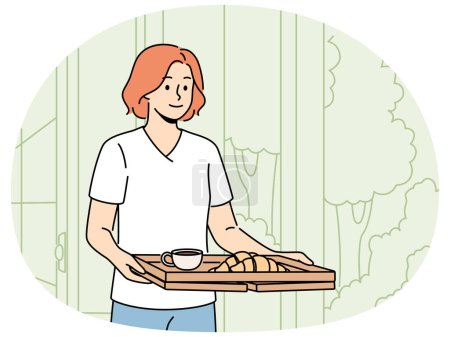 Woman wants to have breakfast in garden or in backyard of own house carries tray of hot tea and croissants. Happy girl carries delicious breakfast on tray to satisfy hunger before hard day at work.