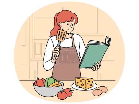 Femme avec livre de cuisine est debout dans la cuisine voulant cuisiner délicieux dîner et légumes et fromage avec des ?ufs. Fille cuisinier dans tablier utilise livre de cuisine lors de la préparation de salade ou hors-d'?uvre