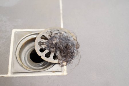 clogged pipe, anti-odor strainer with foul-smelling garbage in the bathroom