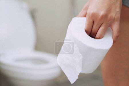 Photo for A woman diarrhea excreting in the bathroom at home - Royalty Free Image