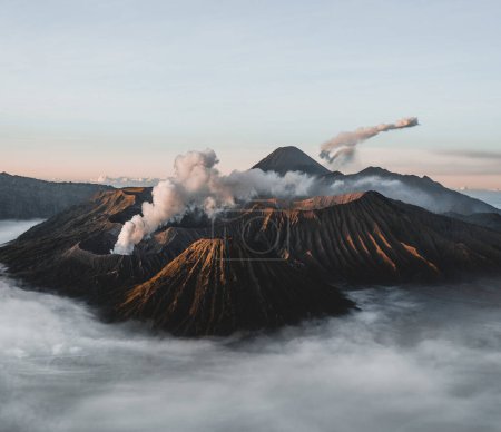 Photo for Mount Bromo volcano Gunung Bromo in Bromo Tengger Semeru National Park, East Java, Indonesia. Sunrise with soft light and smoke. Semeru eruption in background. Photo taken in Indonesia. - Royalty Free Image
