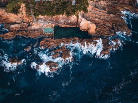 Photo for Aerial drone view of Blue Pool in Bermagui during sunrise sunset with blue sky and reflection. New South Wales, Australia. - Royalty Free Image