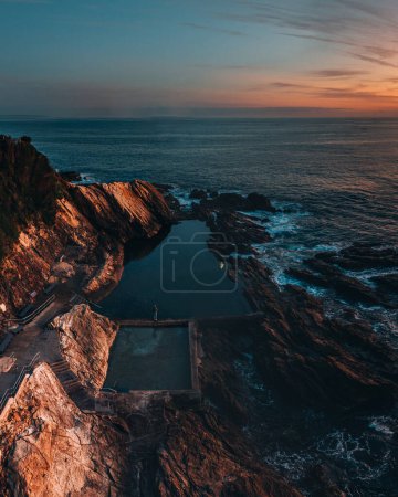 Photo for Blue pool Rock Pool in Bermagui, New South Wales. Aerial drone shot during sunrise with wam colors, Australia - Royalty Free Image