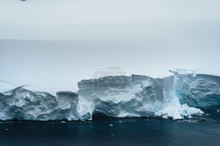 Photo for A floating iceberg in the antarctic peninsula, antarctica and arctic greenland. Global warming and Climate chance concept. Iceberg with hole. Photo taken in Antarctica. - Royalty Free Image