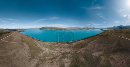 Téléchargez les photos : Vue aérienne du lac glaciaire bleu - lac Tekapo, avec montagnes et ciel bleu, sur l'île du Sud, en Nouvelle-Zélande. - en image libre de droit