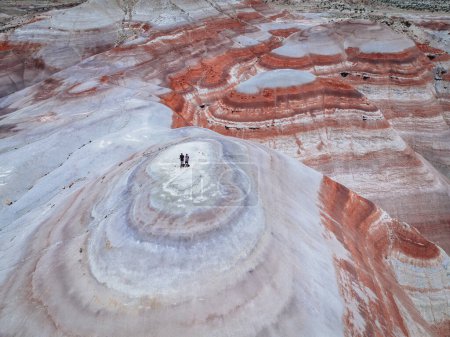 Photo for Bentonite hills Amazing aerial view. Two tourists looking at camera. Located in Capitol Reef National Park, United States, Utah - Royalty Free Image
