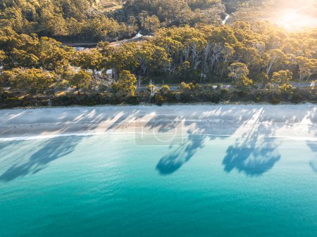 Téléchargez les photos : Drone Birdseye view of Adventure Bay, Tasmanie, Australie. Eau bleue avec ombres au coucher du soleil. Belle plage et concept de voyage - en image libre de droit