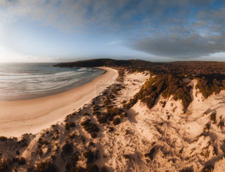 Aerial Drone view One Mile Beach during sunrise sunset with sand dunes. Forster, Great Lakes, Australia.