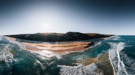 Photo for Kgari High angle aerial birds eye drone view of the Maheno shipwreck on Seventy-Five Mile Beach on Fraser Island, Queensland, Australia. Beautiful sunset light with waves - Royalty Free Image