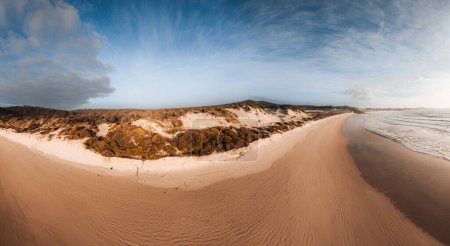 Aerial Drone view One Mile Beach during sunrise sunset with sand dunes. Forster, Great Lakes, Australia.