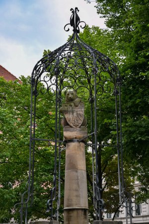 Photo for Wappenbrunnen fountain, depicting bear as coat-of-arms of Berlin in old historical Nikolaiviertel neighborhood near St.Nicholas church - Royalty Free Image