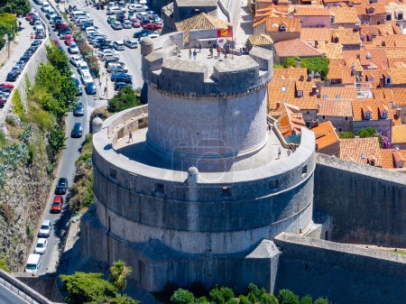 View of Mineta Tower (Tvrava Mineta) the highest point of its defence system, built in 1319 and Walls of Dubrovnik. As a symbol of unconquerable Dubrovnik, upon Minceta tower is the Croatian flag. 