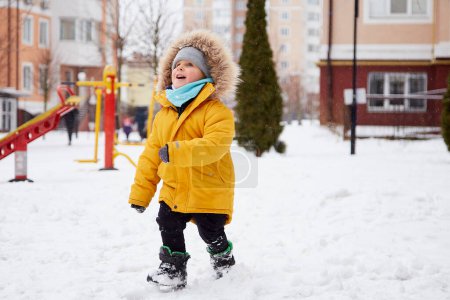 Photo for Happy child in bright orange winter Jacket having fun in the snow. Winter fun outside. Winter holidays. High quality photo - Royalty Free Image