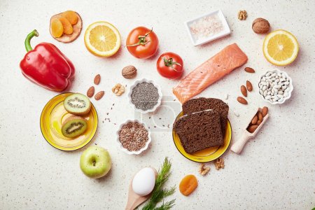  Healthy FODMAP diet food in heart shape. Organic fruits, vegetables, greenery, nuts, beans, flax seeds, chia seeds, wholegrain bread