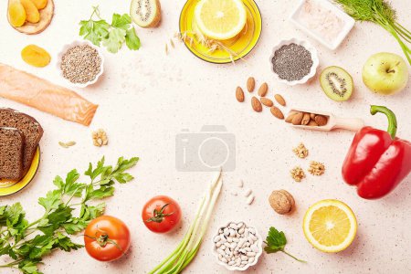  Healthy FODMAP diet food with copy space. Organic fruits, vegetables, greenery, nuts, beans, flax seeds, chia seeds, wholegrain bread