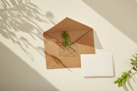 Photo for Craft paper open envelope and stationery card mock up under sunny shadows. Copy space. - Royalty Free Image