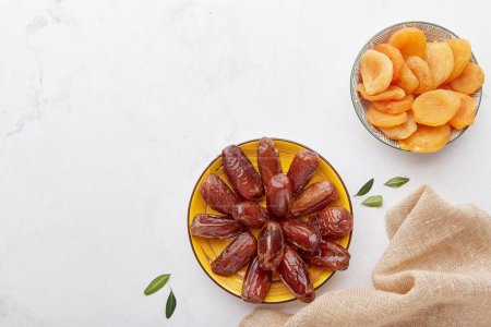 Photo for Gluten and sugar free snacks, healthy desserts. Fast diet food - dried apricots, dates. - Royalty Free Image