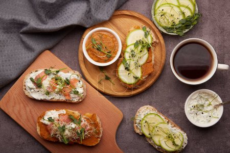 Photo for Vegetarian breakfast - sandwiches with zucchini and yogurt cheese spread, alfalfa, sprouted peas, salmon, garlic sauce with coffee. Low in calories breakfast, FODMAP, Keto superfood. - Royalty Free Image