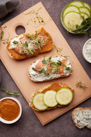 Photo for Morning table - sandwiches with zucchini spread and greek yogurt, smoked salmon. Low in calories, FODMAP, KETO diet, superfood flat lay - Royalty Free Image