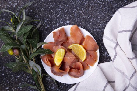 Photo for Elegant Smoked Salmon Platter with Fresh Lemon Garnish. - Royalty Free Image