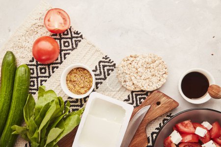  Aesthetic healthy low fodmap food ingredients with copy space - vegetables, fruits, greens, salad with feta. Flat lay