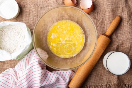Photo for Home Baking - whisking eggs for homemade cake. Rustic recipe with eggs, wholegrain flour, sugar and kefir. - Royalty Free Image