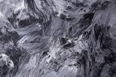 Monochrome abstract painting with fluid patterns and textures.