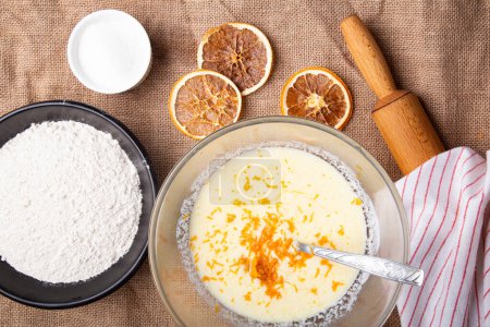 Photo for Home Baking - Blending Orange Peel with Basic Baking Ingredients. - Royalty Free Image
