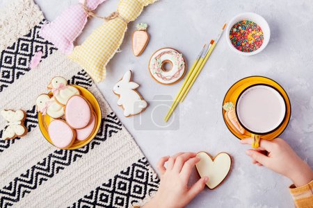 Cozy kid snack time. Tradition cookies decoration by kid flat lay.