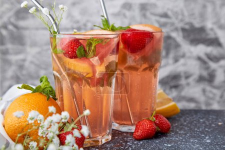Refreshing aesthetic cocktails with citrus fruits and strawberry. Vitaminized summer detox water. Low alcohol, zero proof beverages