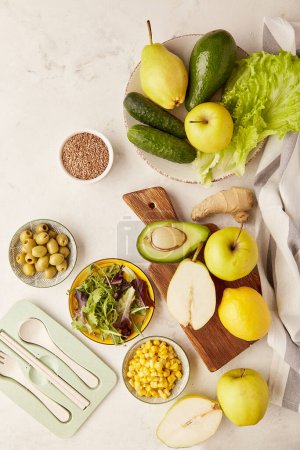 Healthy organic vegan food. Plant based diet, Fodmap,Mediterranean diet - vegetables, fruits, greens, flax seeds ingredients with cutlery.