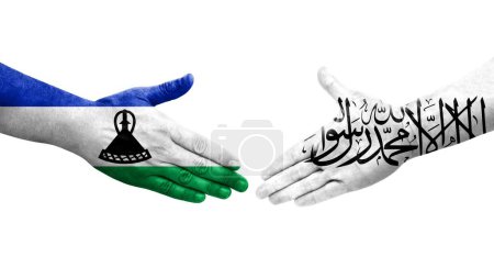 Foto de Apretón de manos entre Afganistán y Lesotho banderas pintadas en las manos, imagen transparente aislada. - Imagen libre de derechos