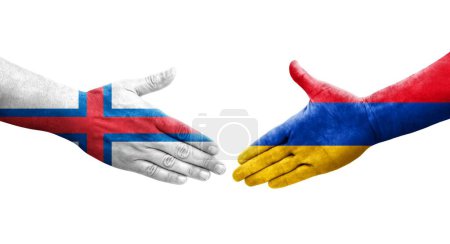 Poignée de main entre l'Arménie et les îles Féroé drapeaux peints sur les mains, image transparente isolée.