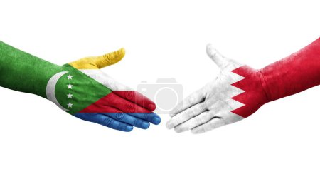 Photo for Handshake between Bahrain and Comoros flags painted on hands, isolated transparent image. - Royalty Free Image