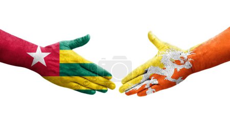 Photo for Handshake between Bhutan and Togo flags painted on hands, isolated transparent image. - Royalty Free Image