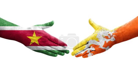 Photo for Handshake between Bhutan and Suriname flags painted on hands, isolated transparent image. - Royalty Free Image