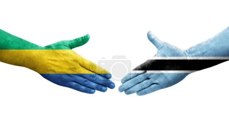 Poignée de main entre les drapeaux Botswana et Gabon peints sur les mains, image transparente isolée.