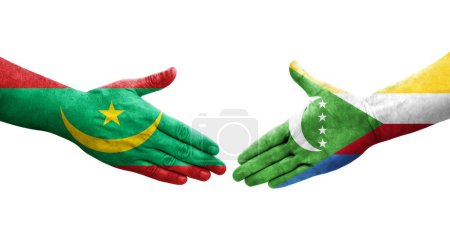 Photo for Handshake between Comoros and Mauritania flags painted on hands, isolated transparent image. - Royalty Free Image